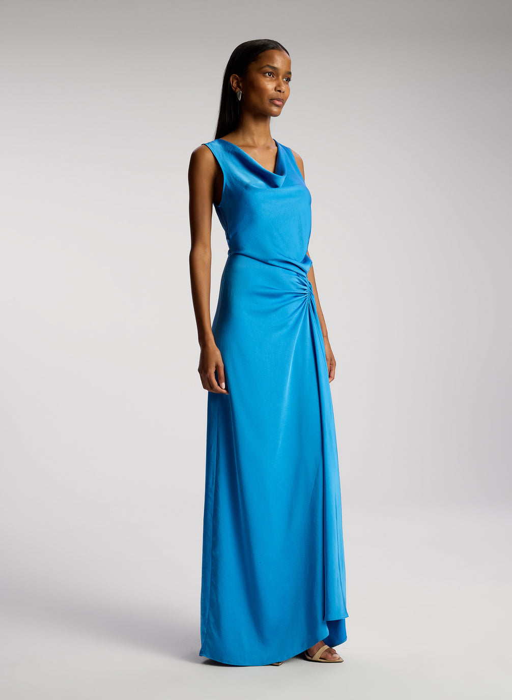 side view of woman wearing blue satin maxi dress