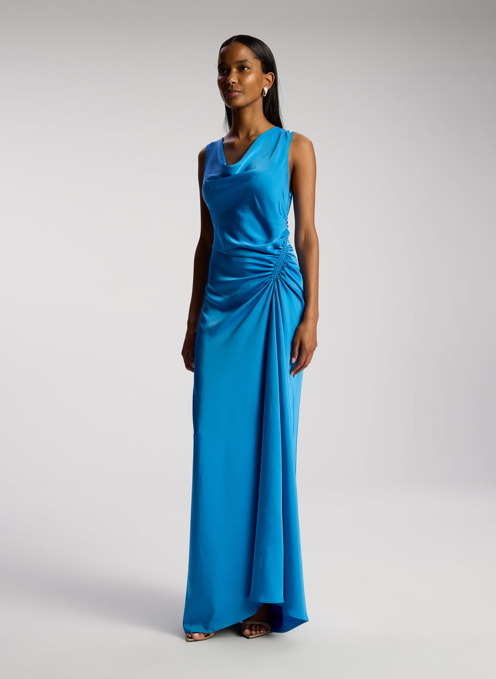 side view of woman wearing blue satin maxi dress