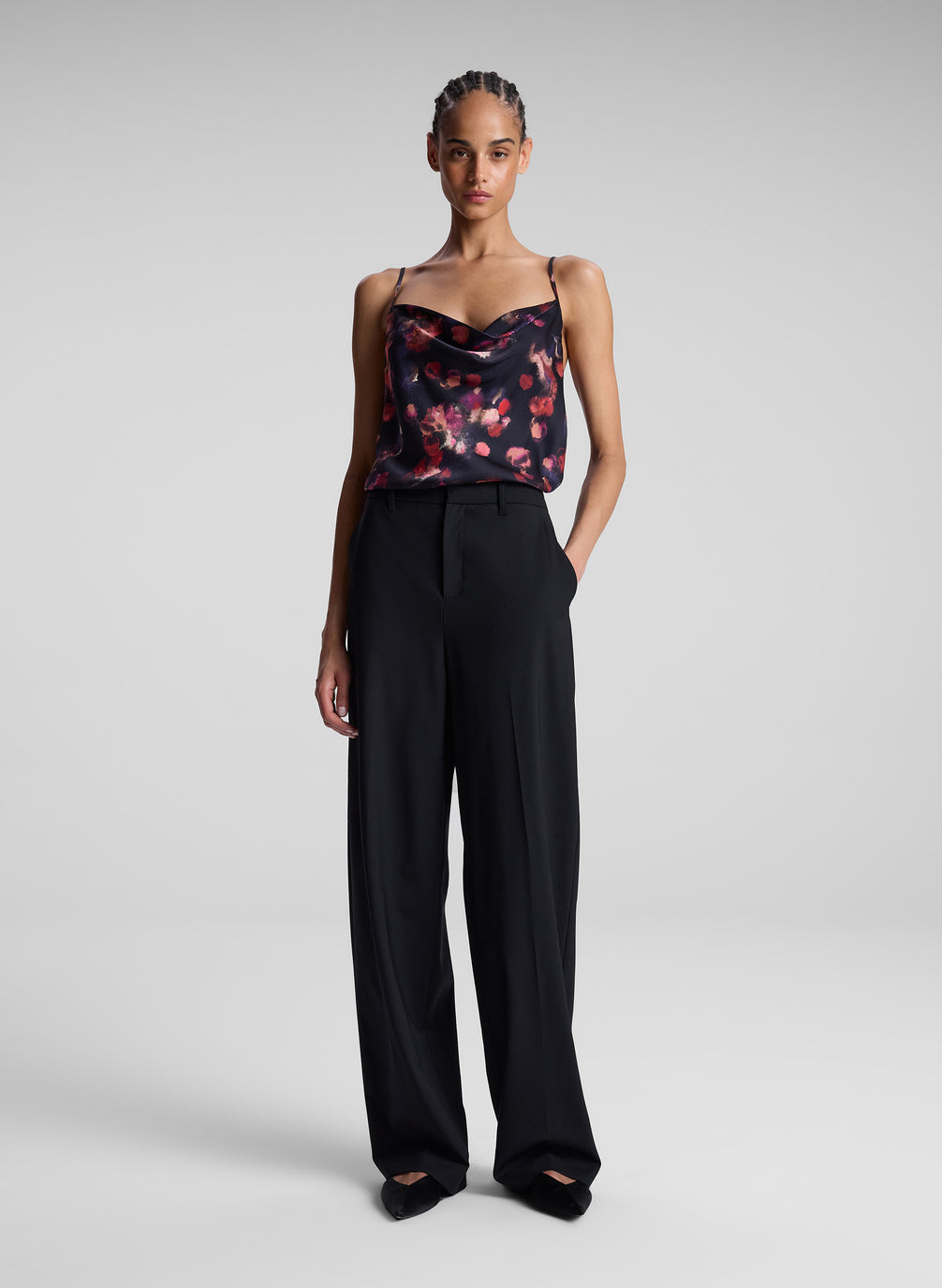 woman wearing printed satin camisole and black pants