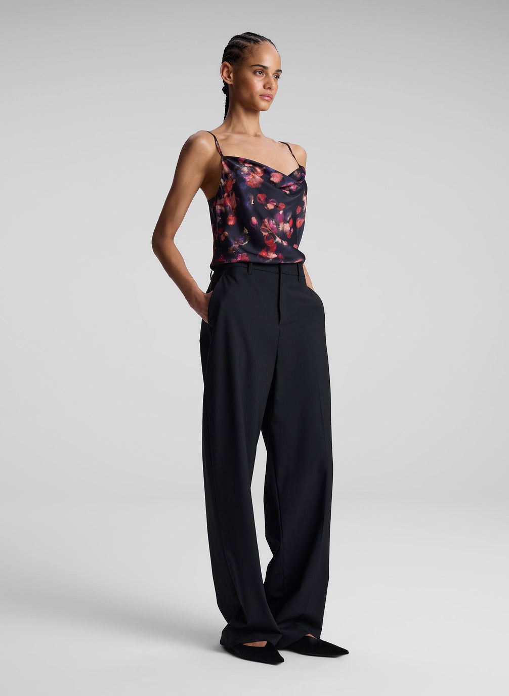 woman wearing printed satin camisole and black pants