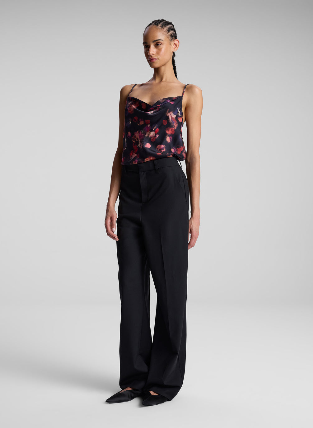 woman wearing printed satin camisole and black pants