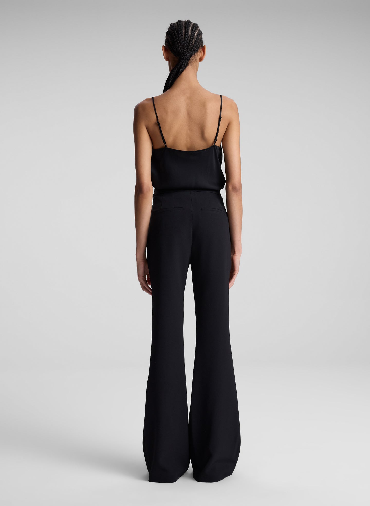 woman wearing black camisole and black pants