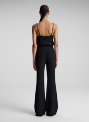 woman wearing black camisole and black pants