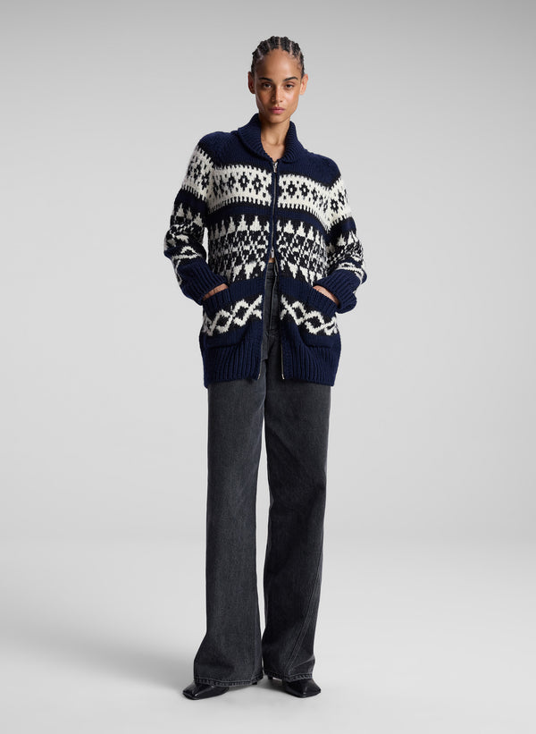 woman in navy fairisle cardigan and black denim