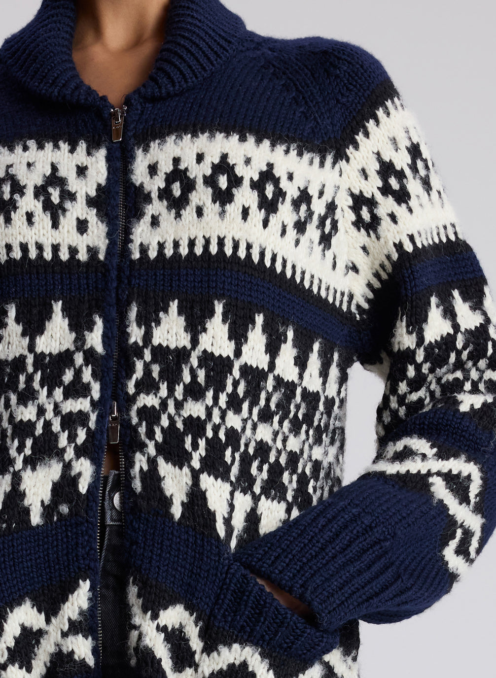 woman in navy fairisle cardigan and black denim