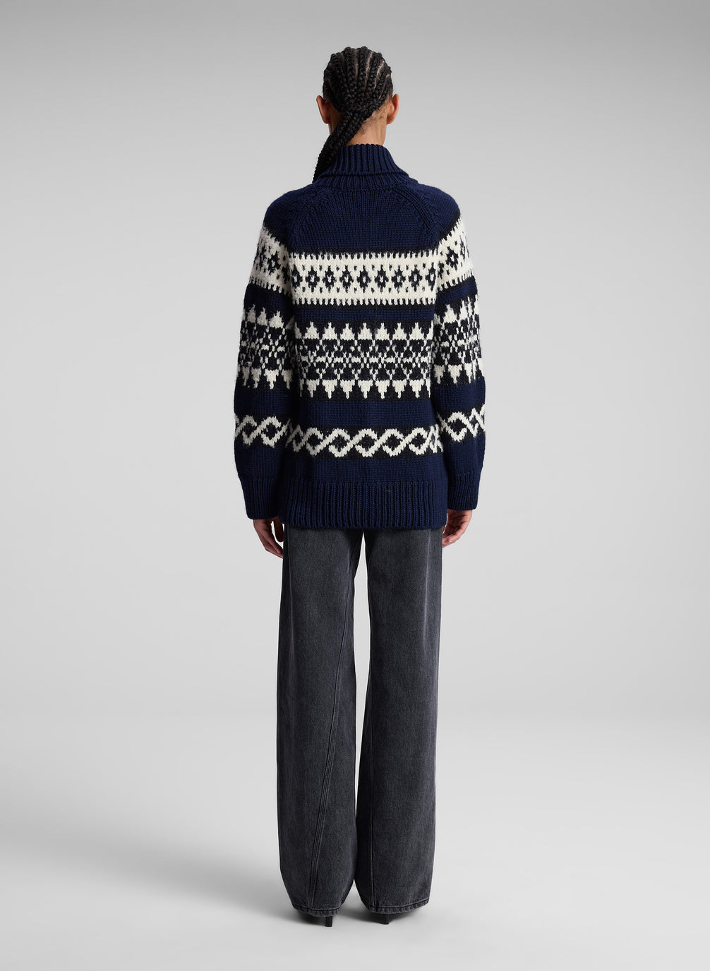 woman in navy fairisle cardigan and black denim