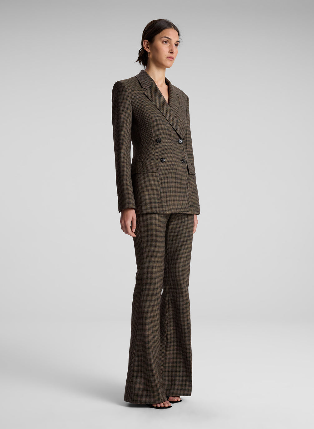 woman wearing brown houndstooth suit