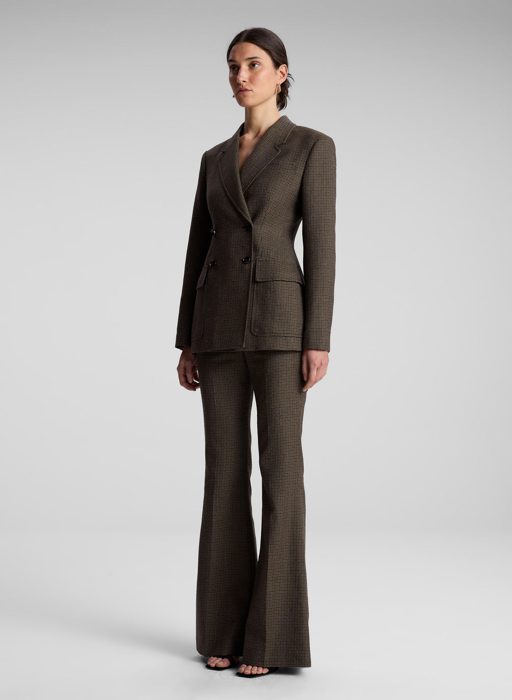 woman wearing brown houndstooth suit