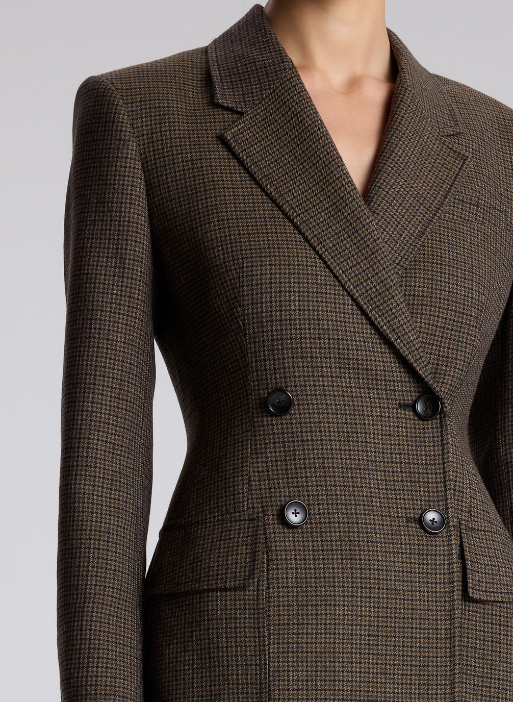 woman wearing brown houndstooth suit