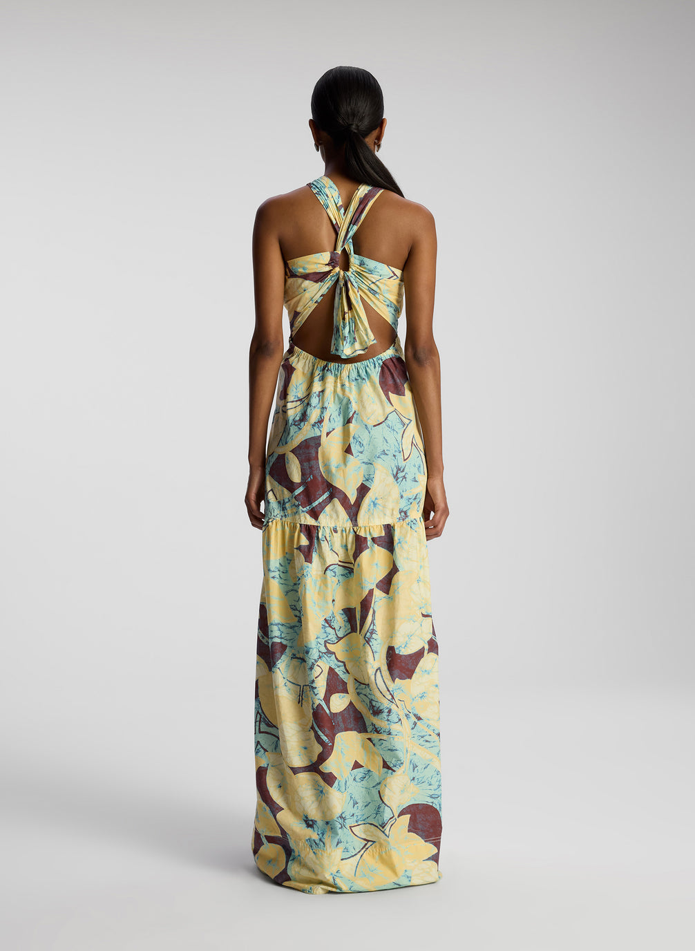 back view of woman wearing printed maxi dress