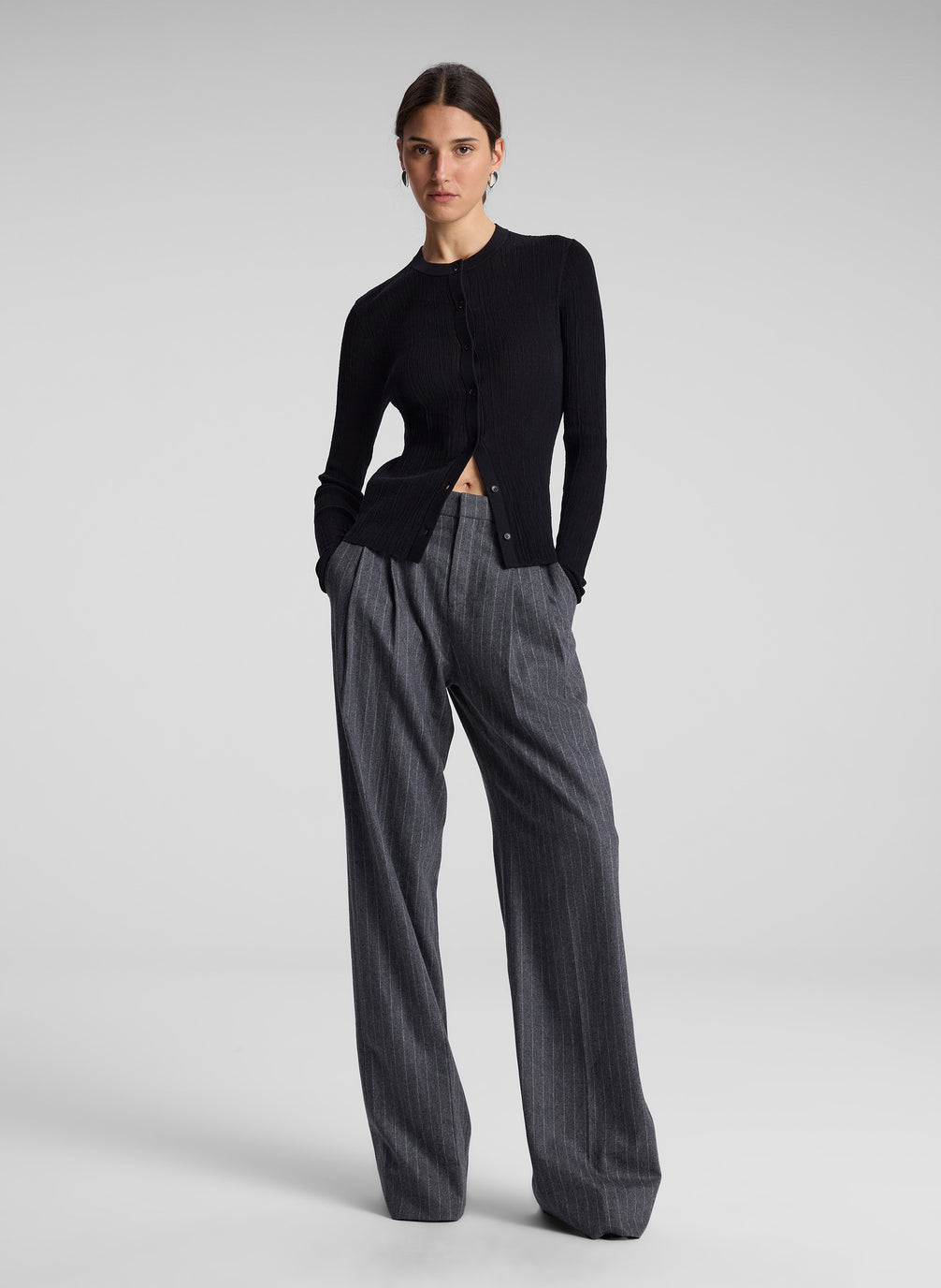 woman wearing black cardigan and grey pinstripe pant