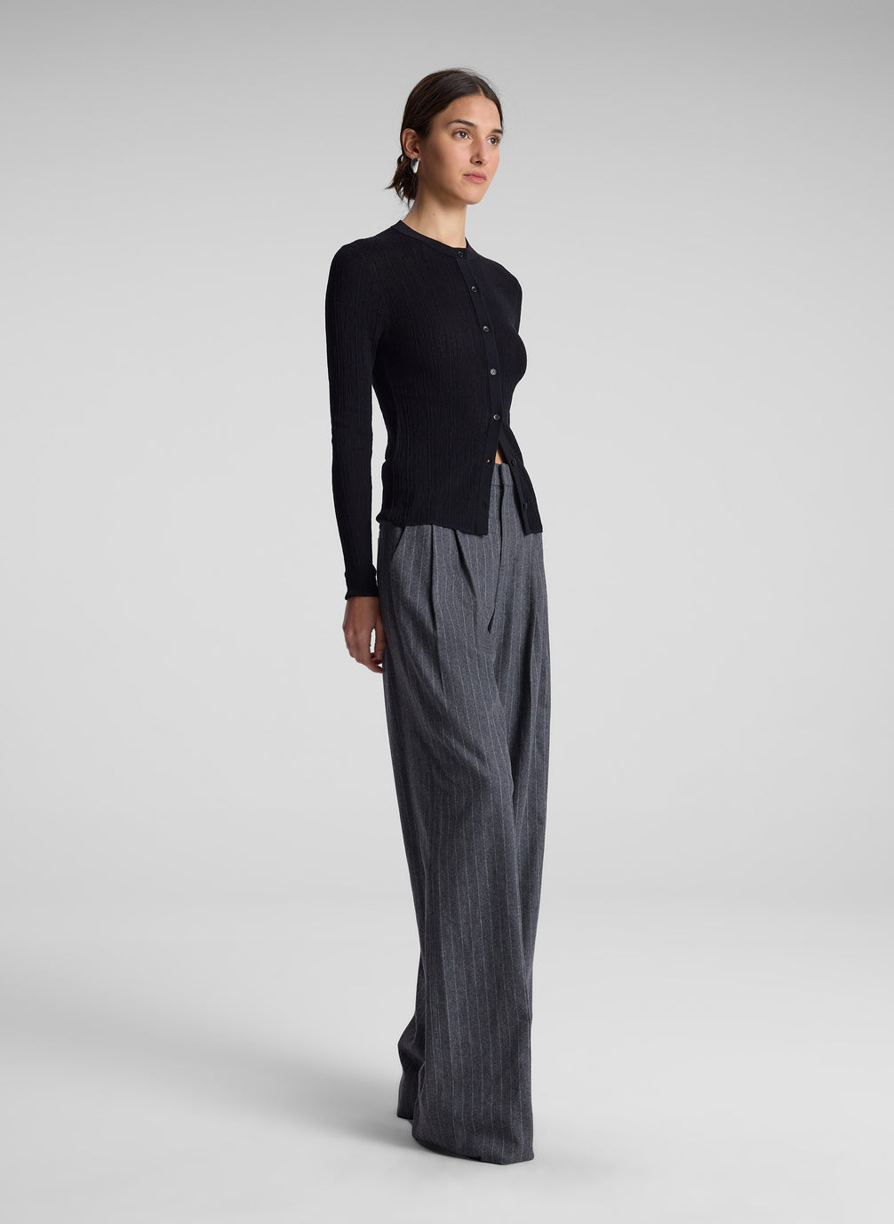 woman wearing black cardigan and grey pinstripe pant