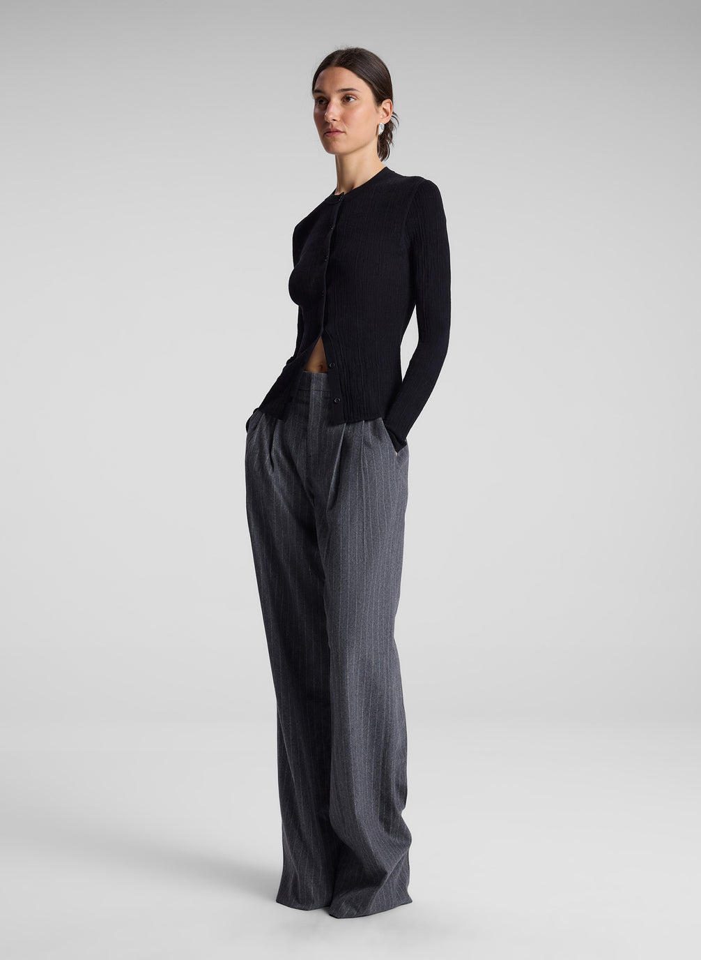 woman wearing black cardigan and grey pinstripe pant