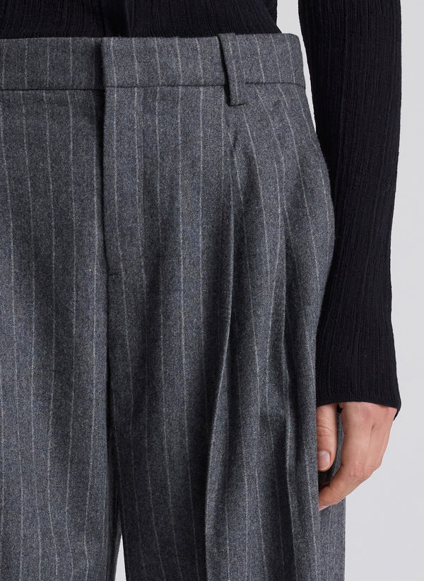 woman wearing black cardigan and grey pinstripe pant