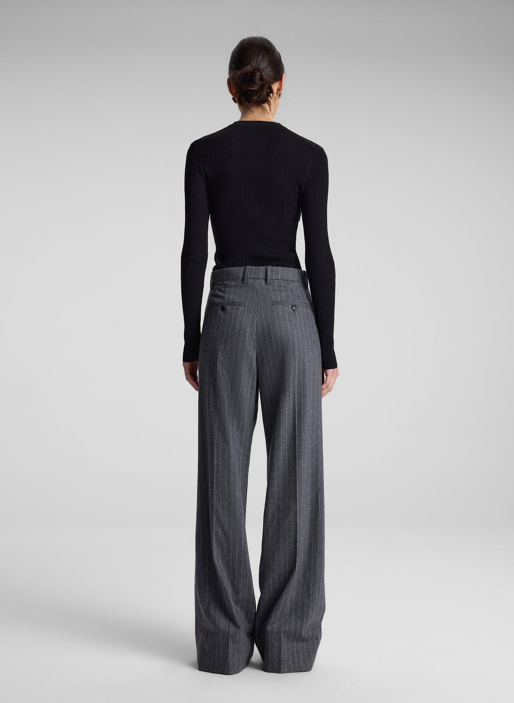 woman wearing black cardigan and grey pinstripe pant