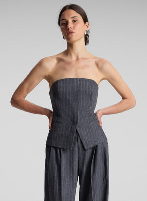 woman wearing grey pinstripe strapless top and matching pants