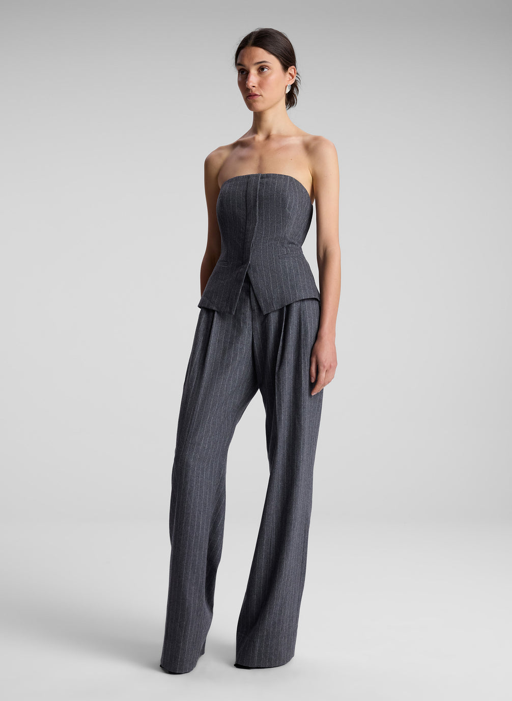 woman wearing grey pinstripe strapless top and matching pants