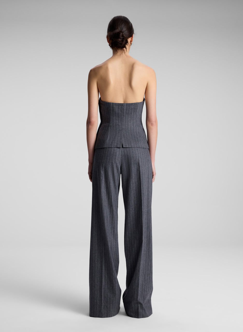 woman wearing grey pinstripe strapless top and matching pants