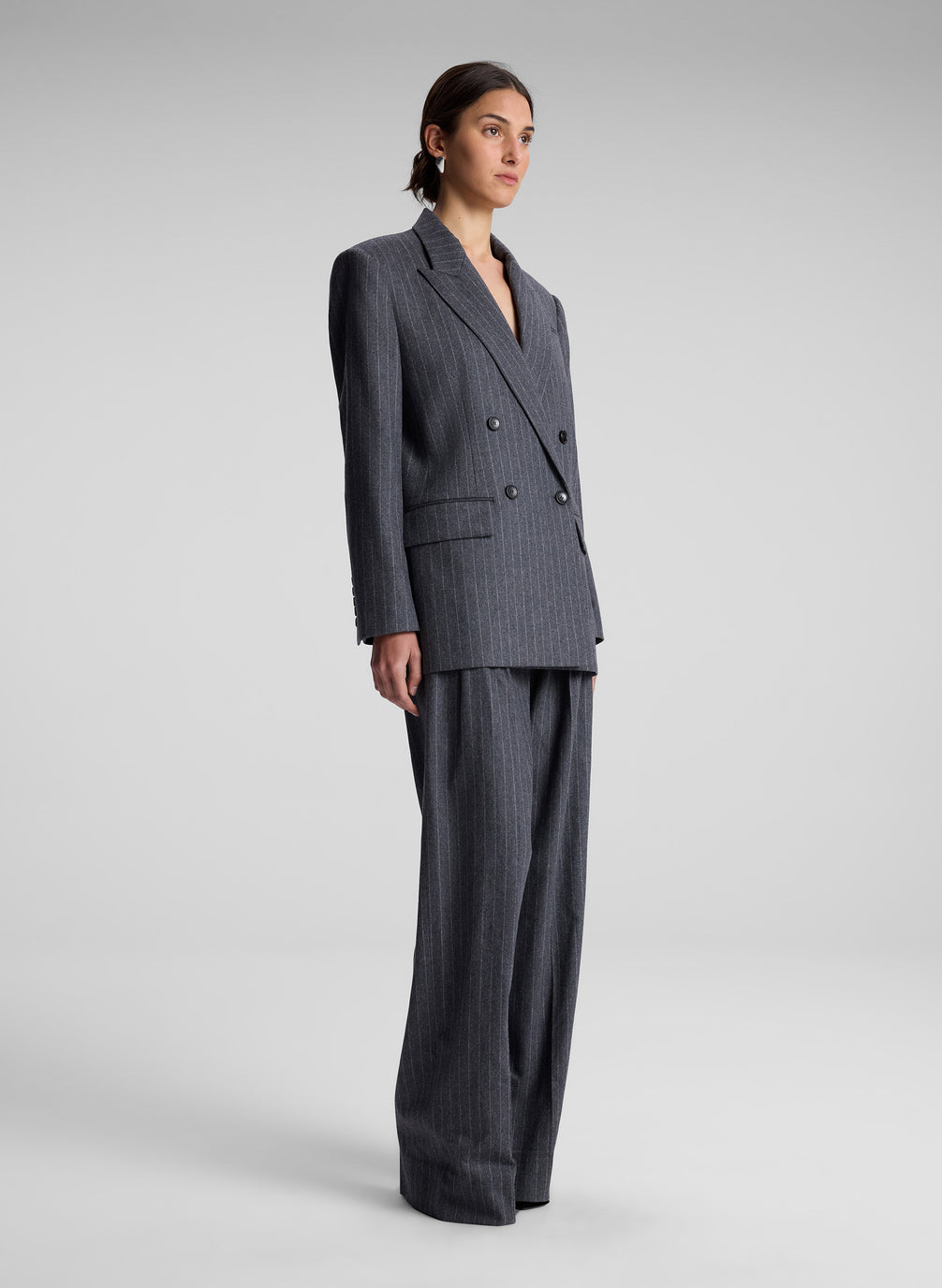 woman wearing oversized grey pinstripe suit