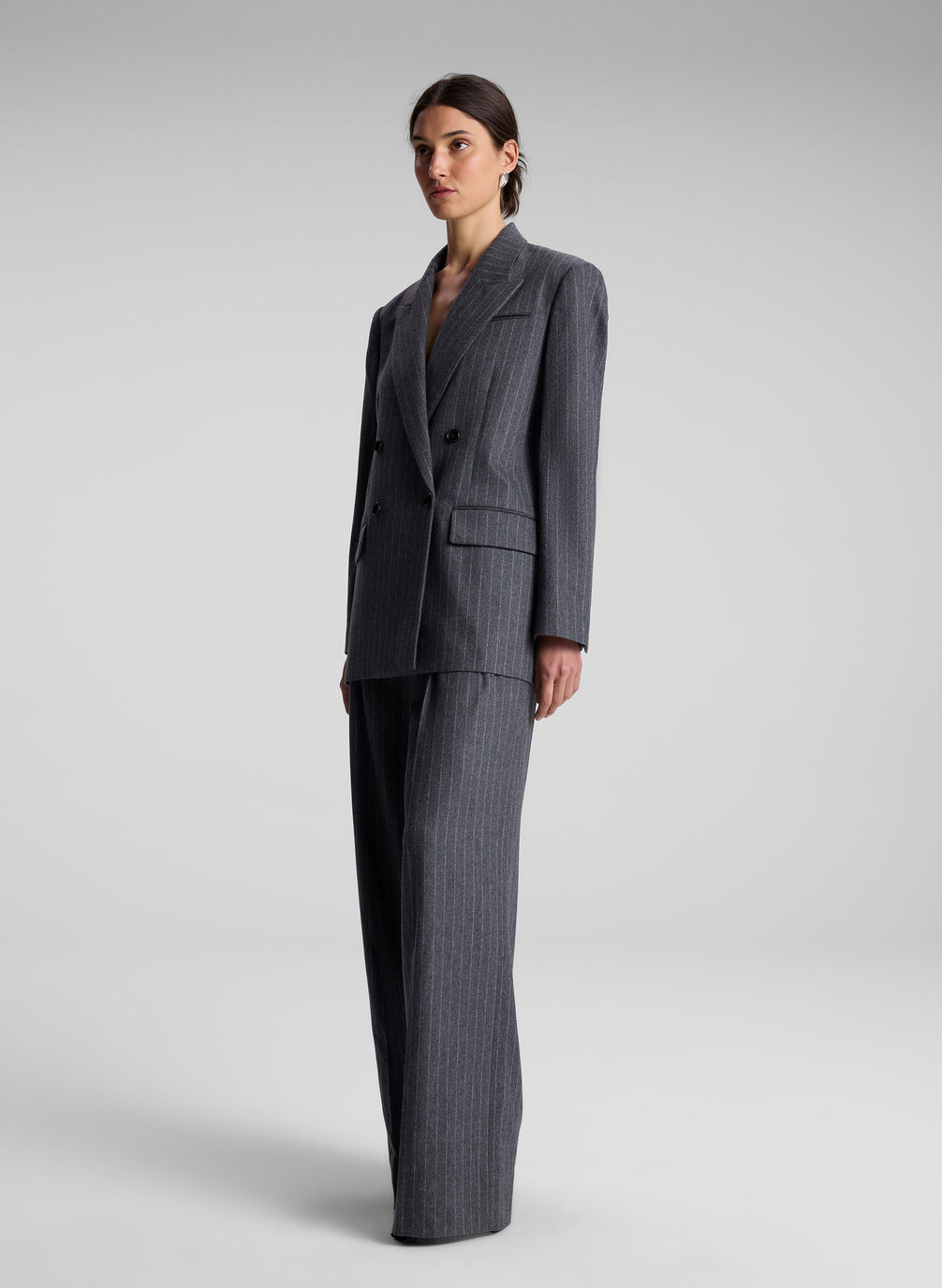 woman wearing oversized grey pinstripe suit