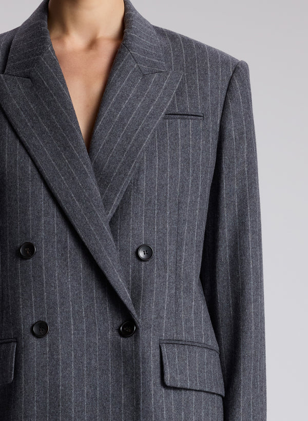 woman wearing oversized grey pinstripe suit