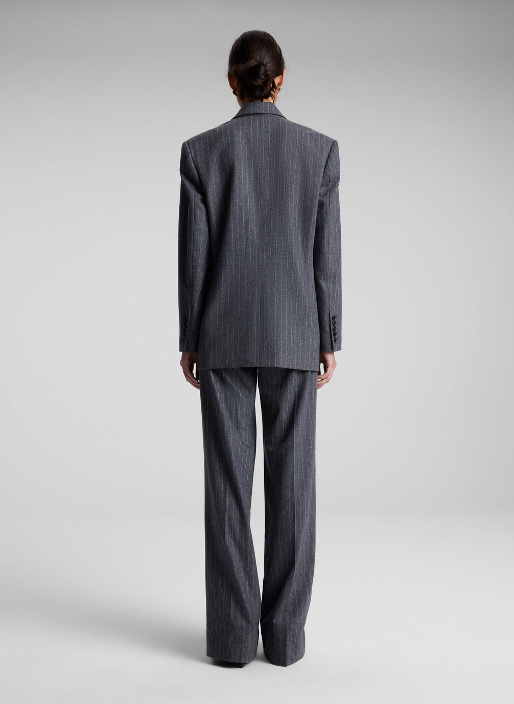 woman wearing oversized grey pinstripe suit