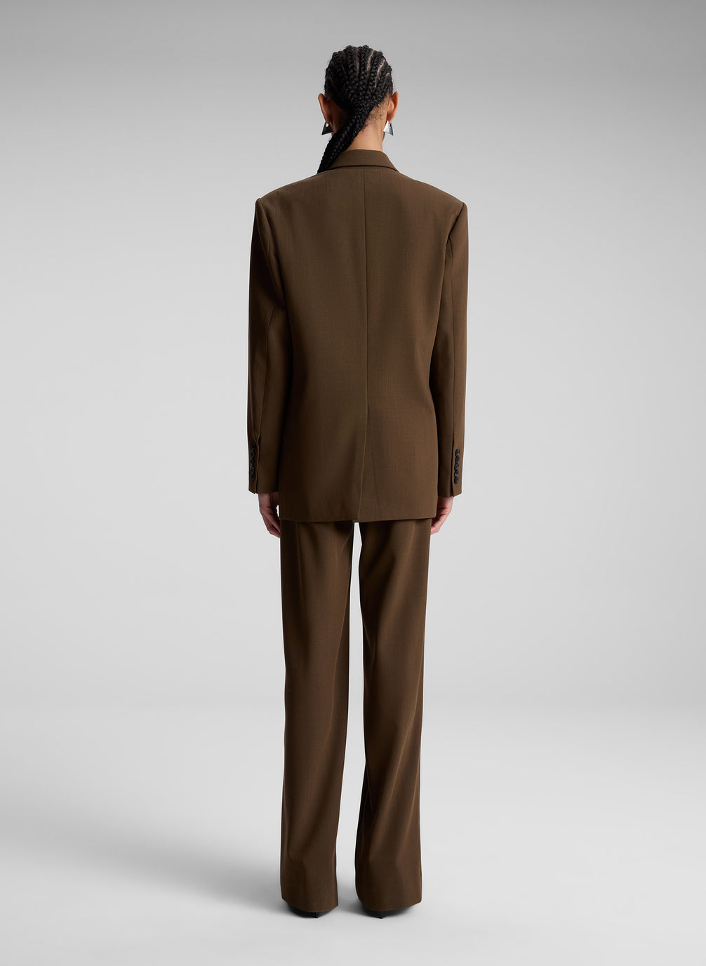 woman wearing brown oversized suit