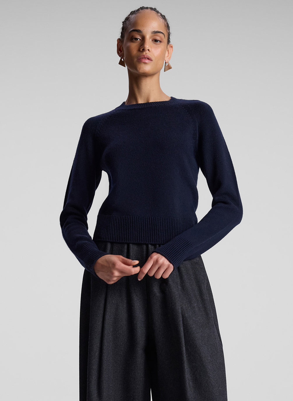 woman wearing navy blue sweater and charcoal grey pants