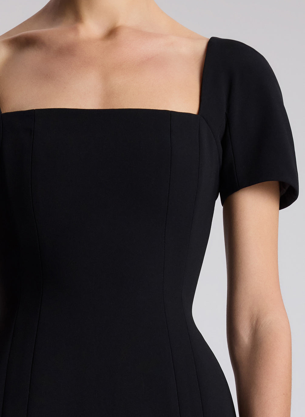 woman wearing black short sleeve midi dress