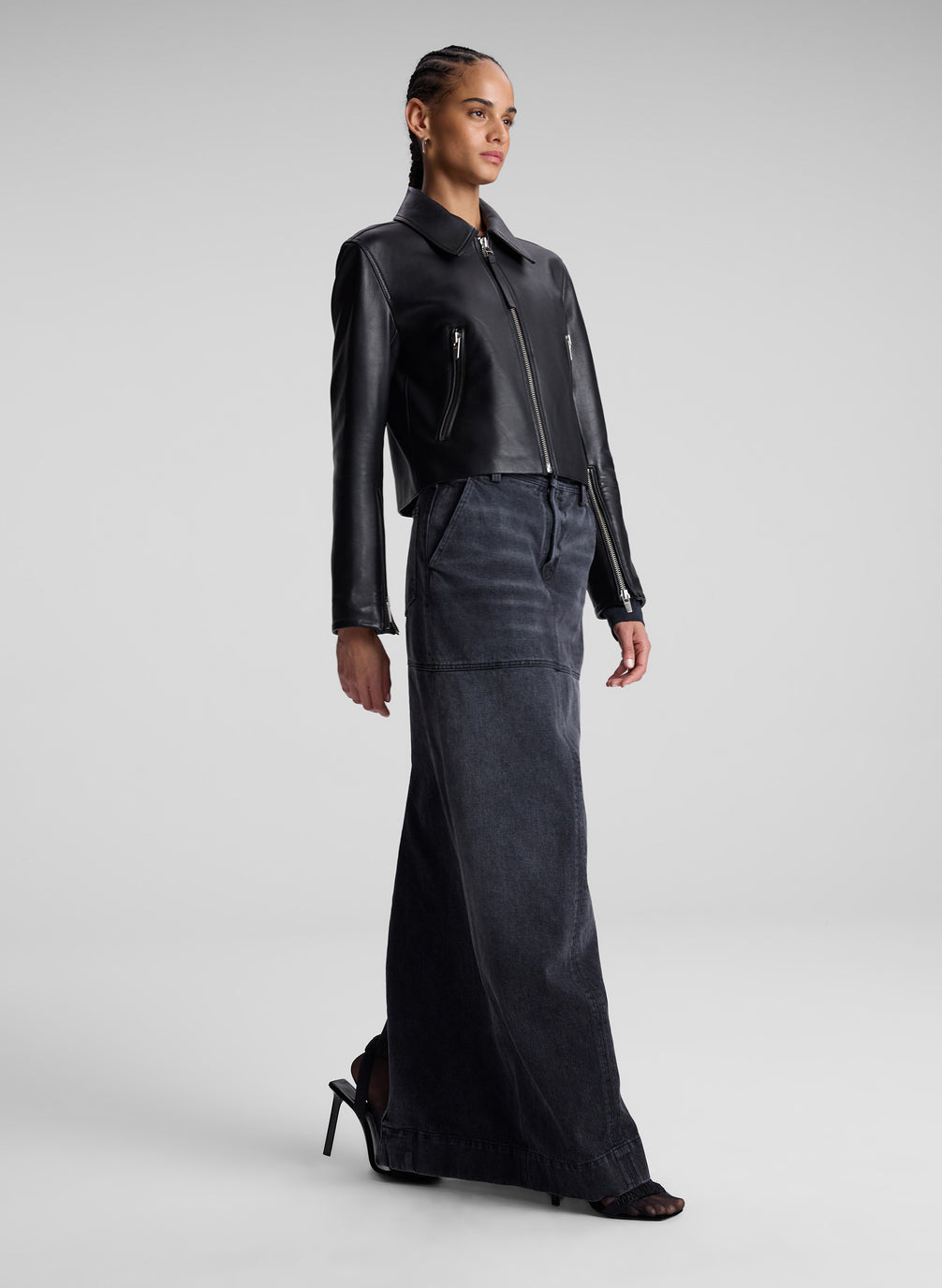 woman wearing black leather jacket and black denim maxi skirt