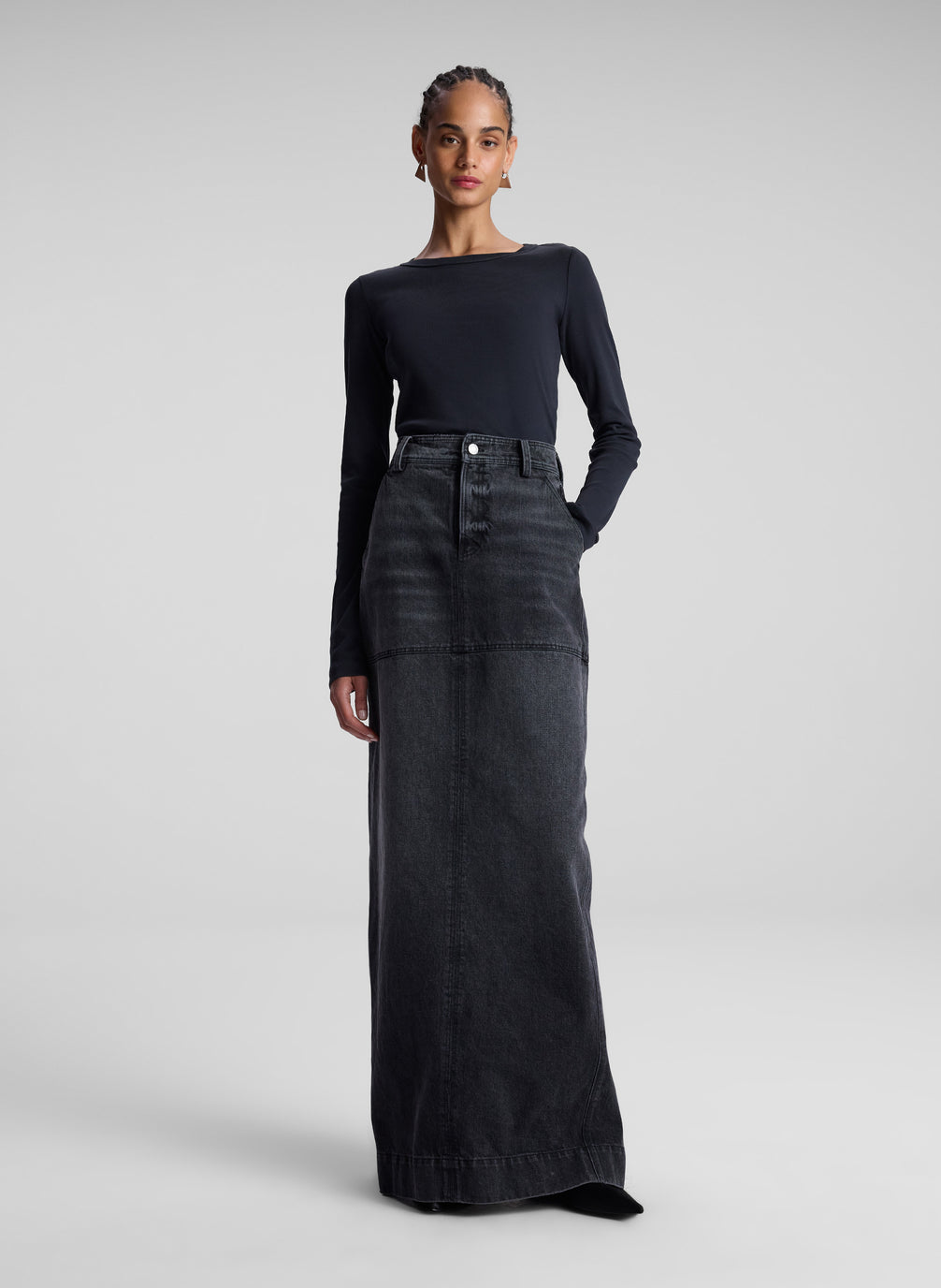 woman wearing black long sleeve tee and black denim maxi skirt