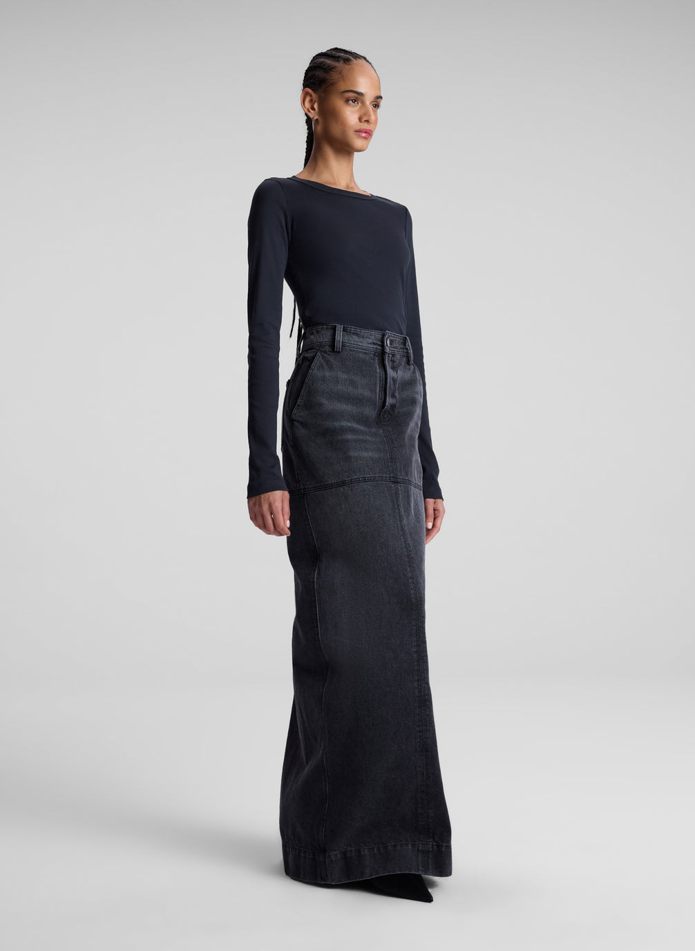 woman wearing black long sleeve tee and black denim maxi skirt