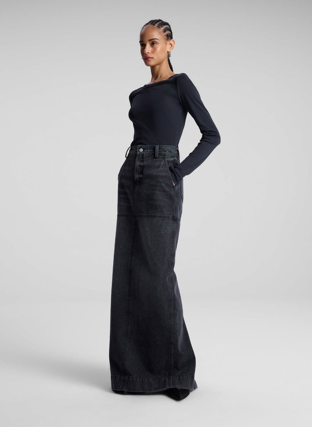 woman wearing black long sleeve tee and black denim maxi skirt