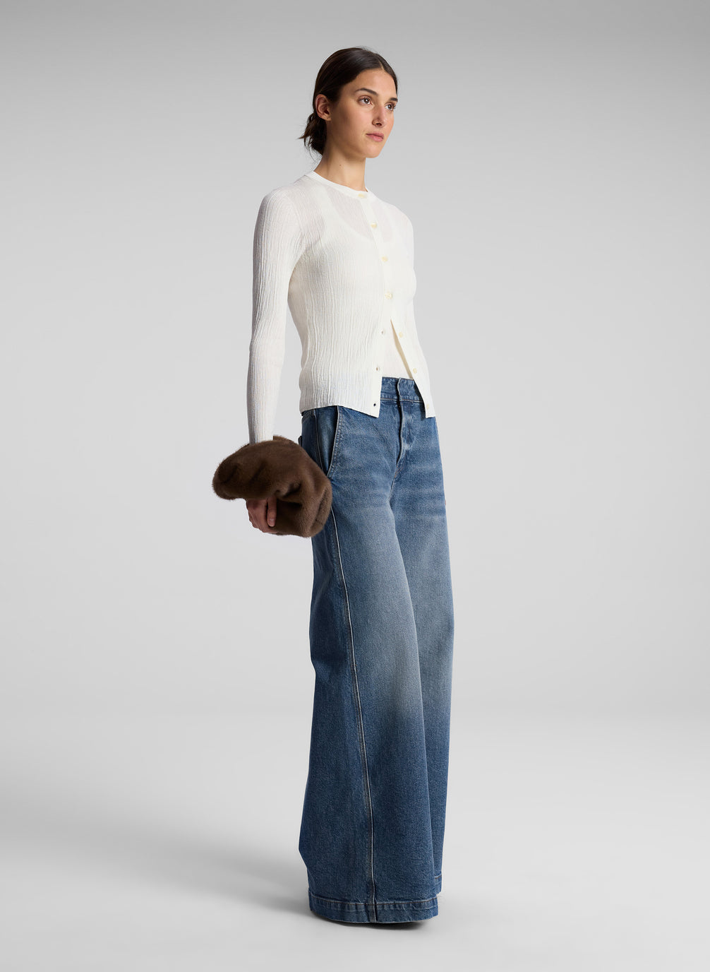 woman wearing white cardigan and jeans