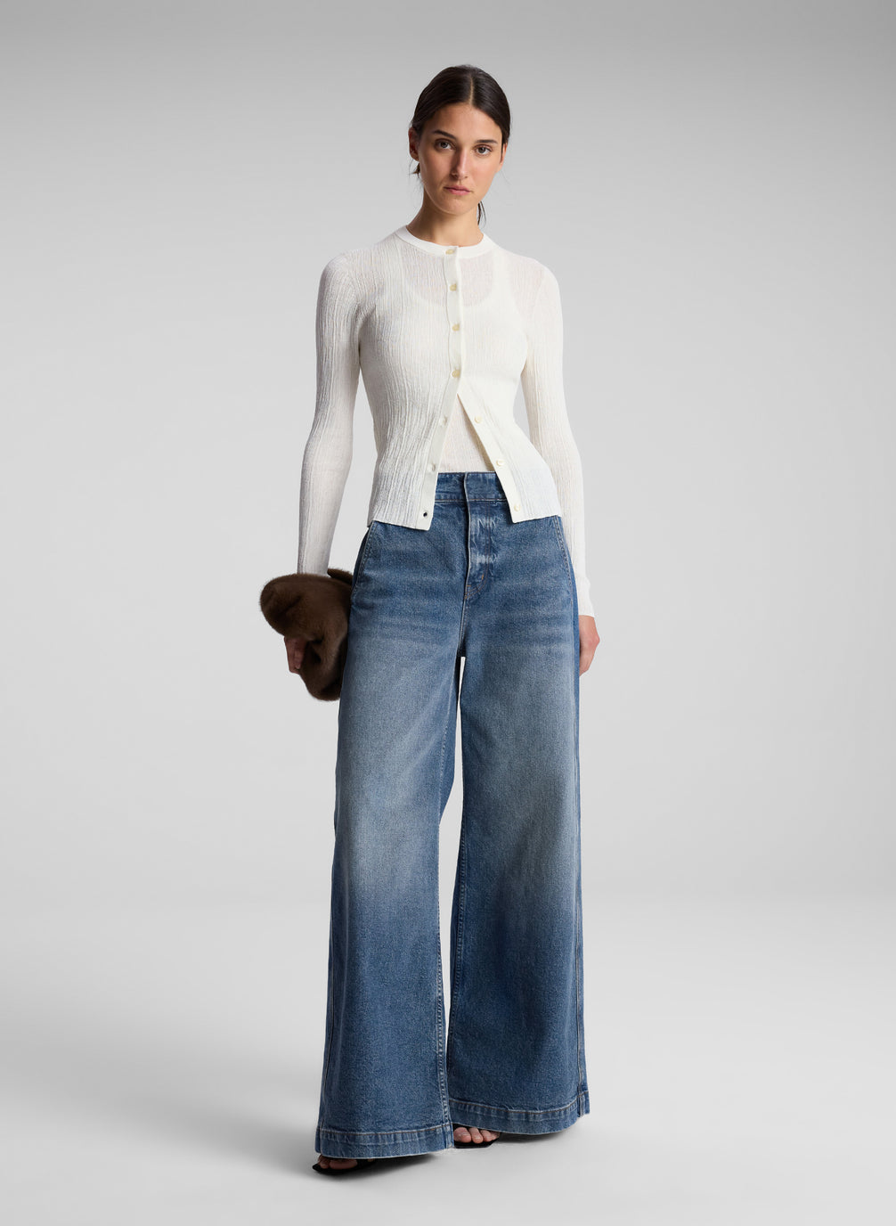 woman wearing white cardigan and jeans