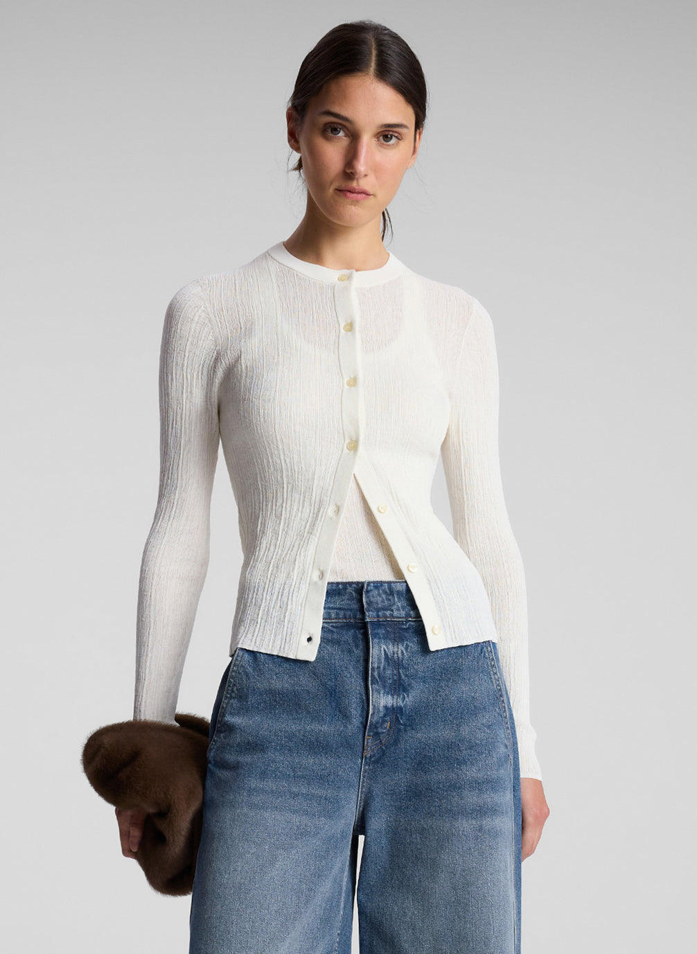 woman wearing white cardigan and jeans