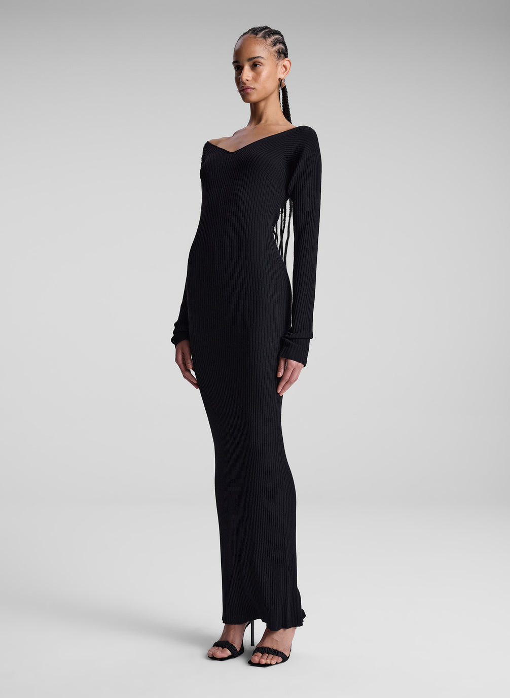 woman wearing black long sleeve maxi dress