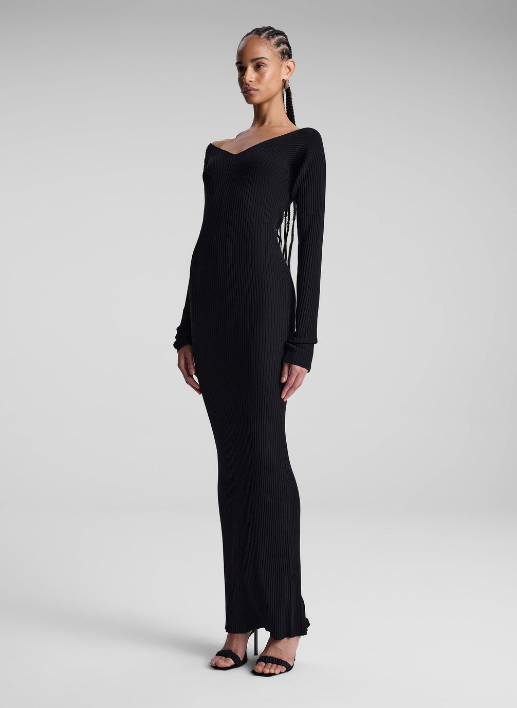 woman wearing black long sleeve maxi dress