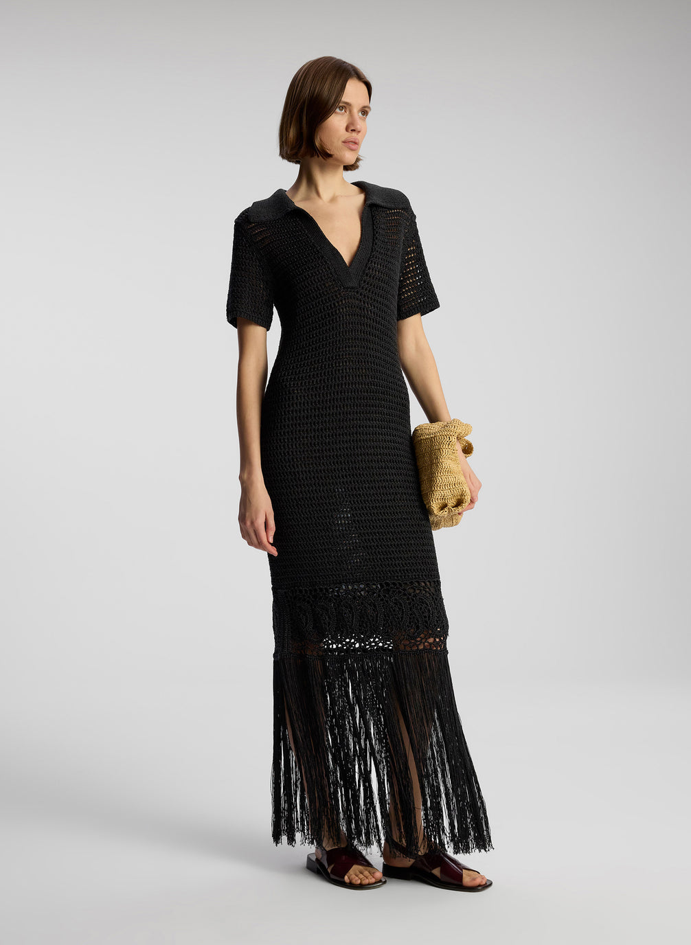 side view of woman wearing black crochet cover up maxi dress