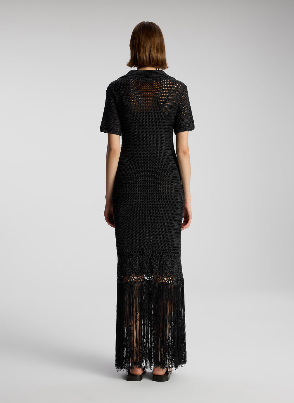 back view of woman wearing black crochet cover up maxi dress