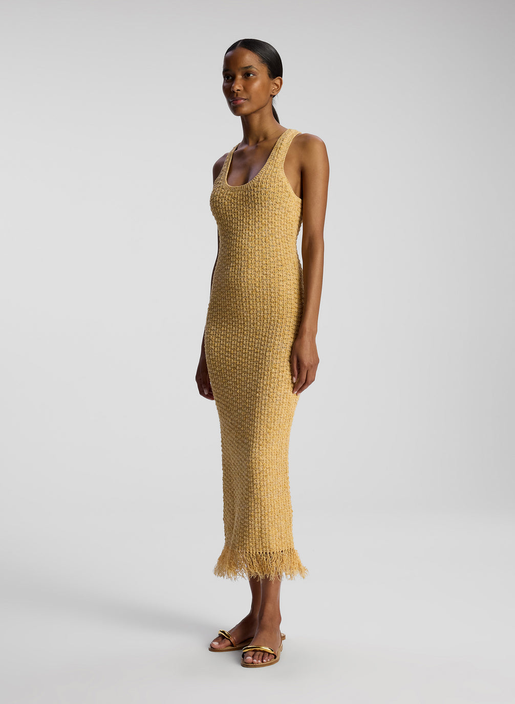 side view of woman wearing tan knit sleeveless midi dress