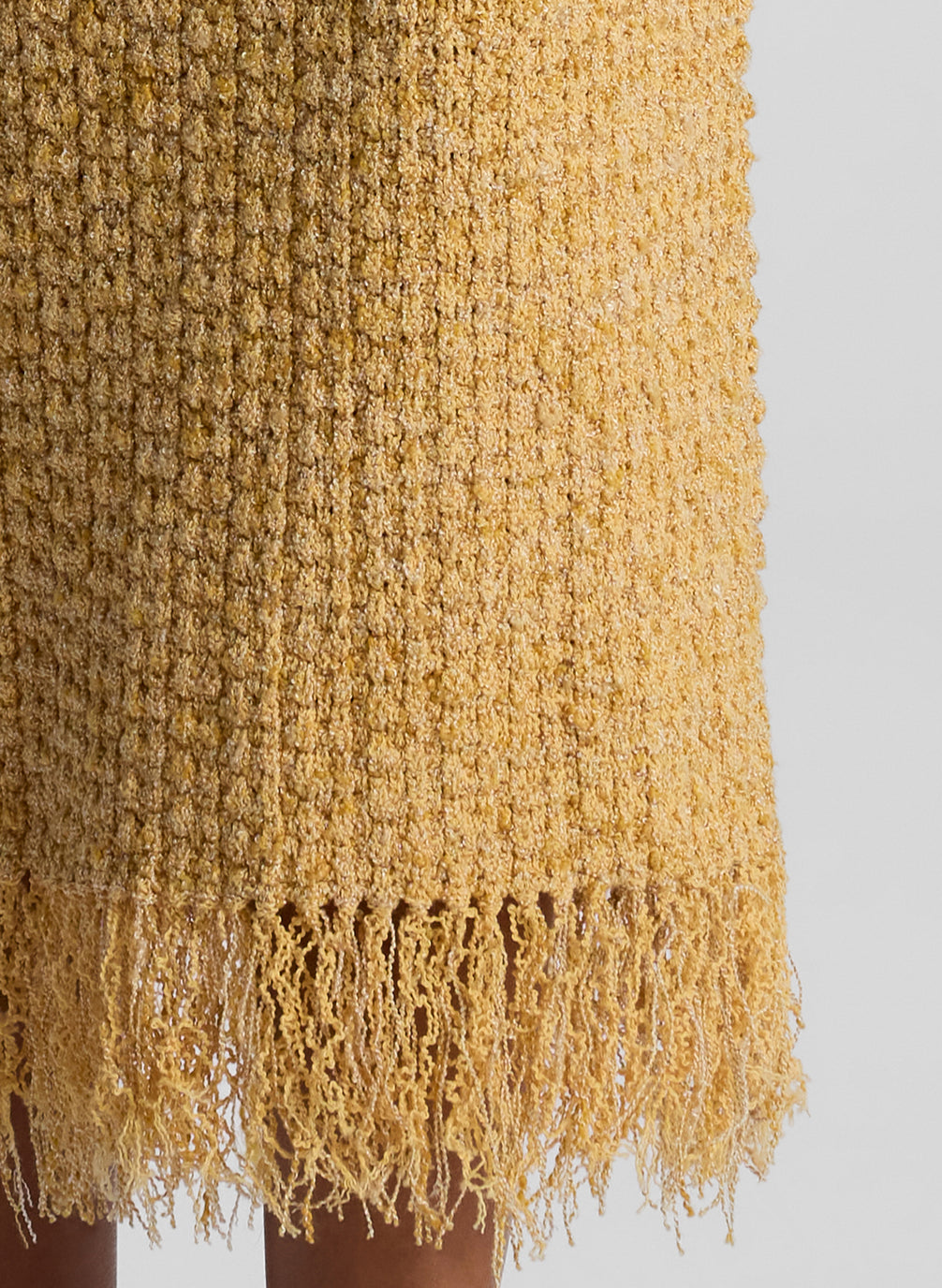 detail view of woman wearing tan knit sleeveless midi dress