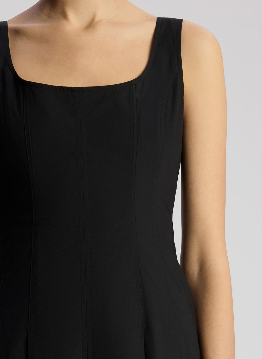 detail  view of woman wearing black sleeveless midi dress