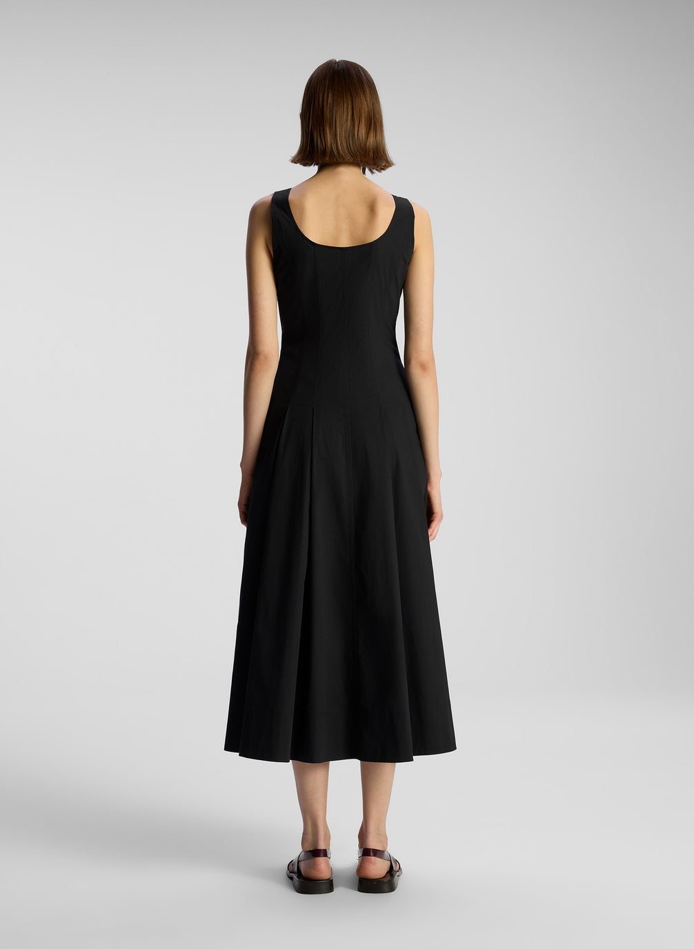 back  view of woman wearing black sleeveless midi dress