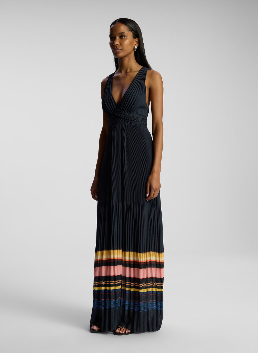 side view of woman wearing navy blue striped maxi dress