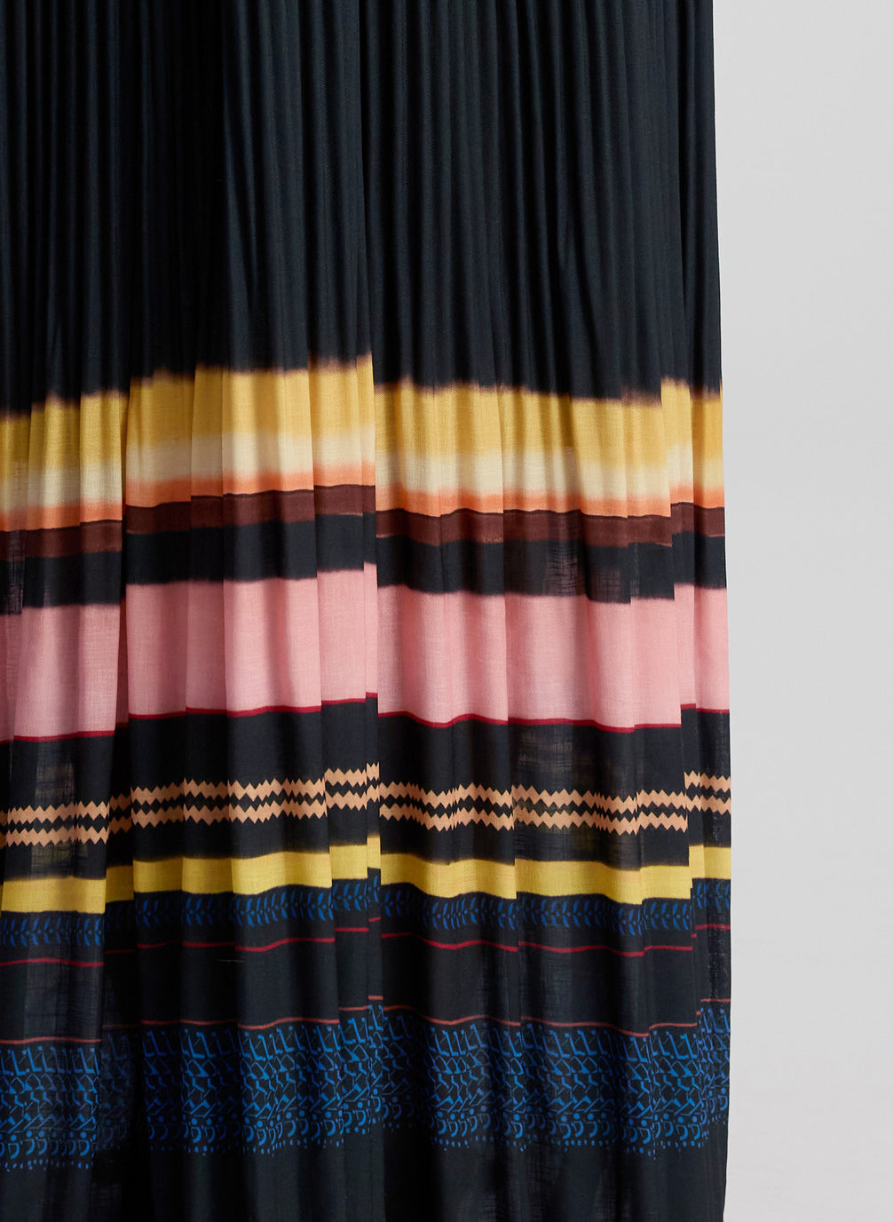 detail view of woman wearing navy blue striped maxi dress