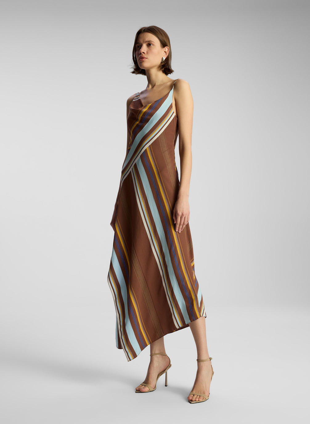 side view of woman wearing brown striped midi dress