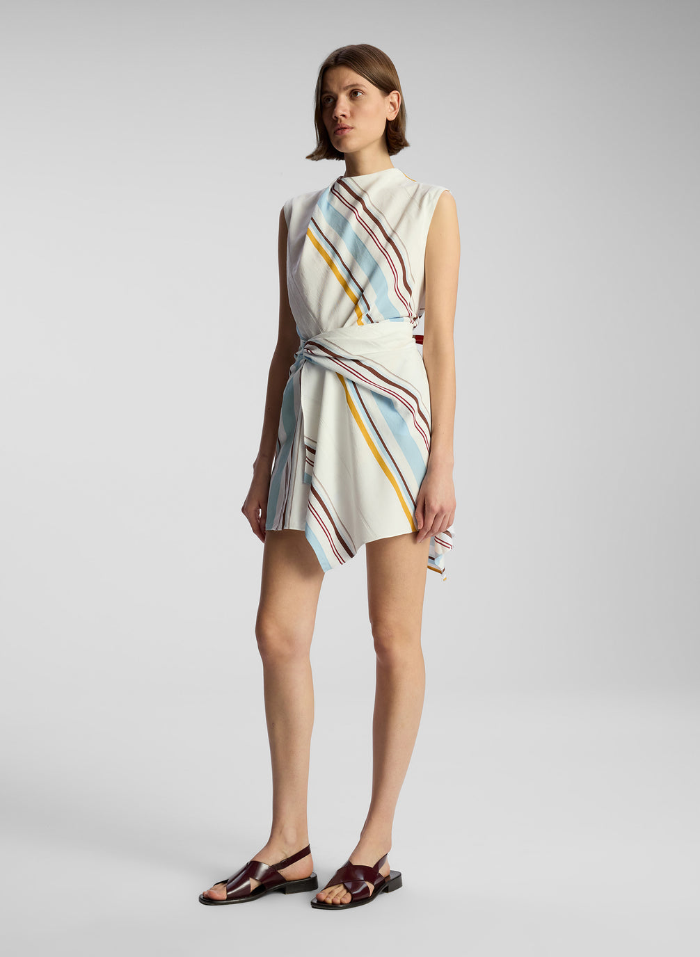 side view of woman wearing multicolor striped mini dress