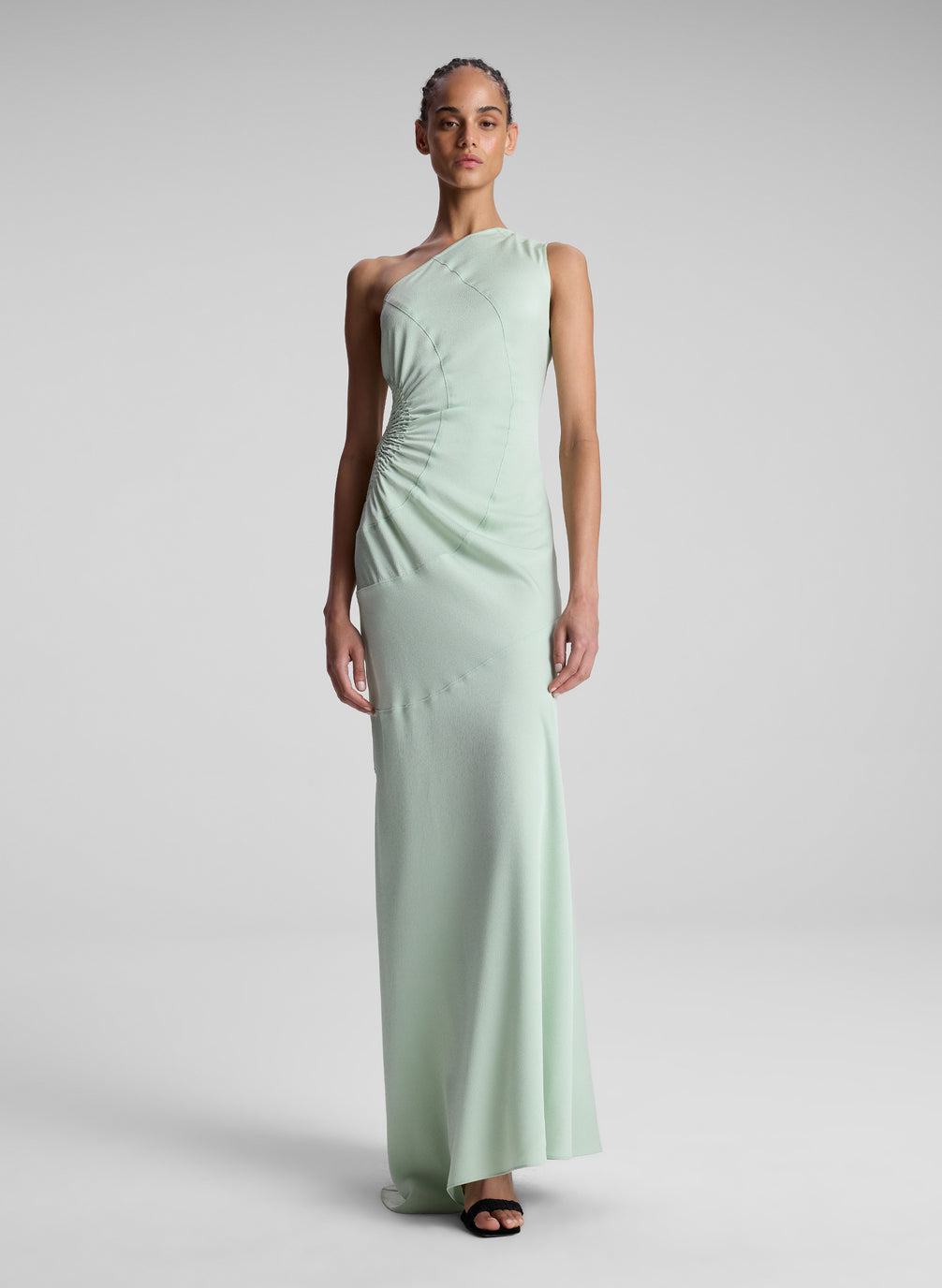 woman wearing light green one shoulder dress