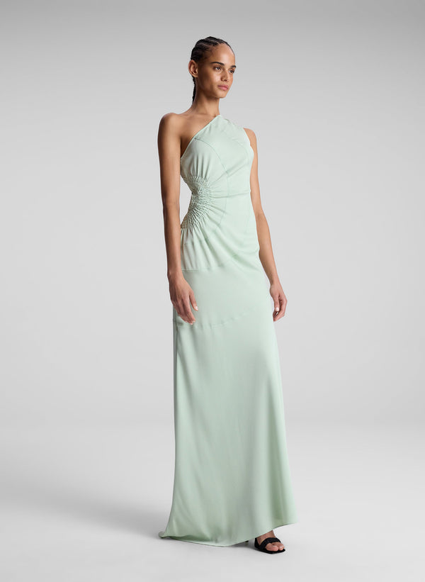 woman wearing light green one shoulder dress